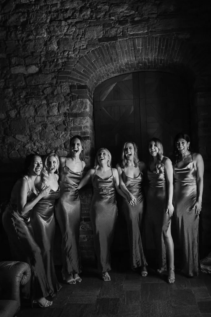 Seven bridesmaids look overjoyed as they see the bride for the first time.