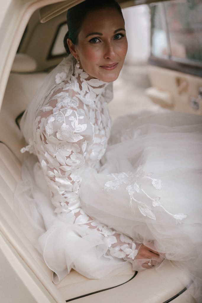 A bride looks straight at the camera before heading off to her church ceremony in the UK, taken by London Wedding Photographer Philip White.