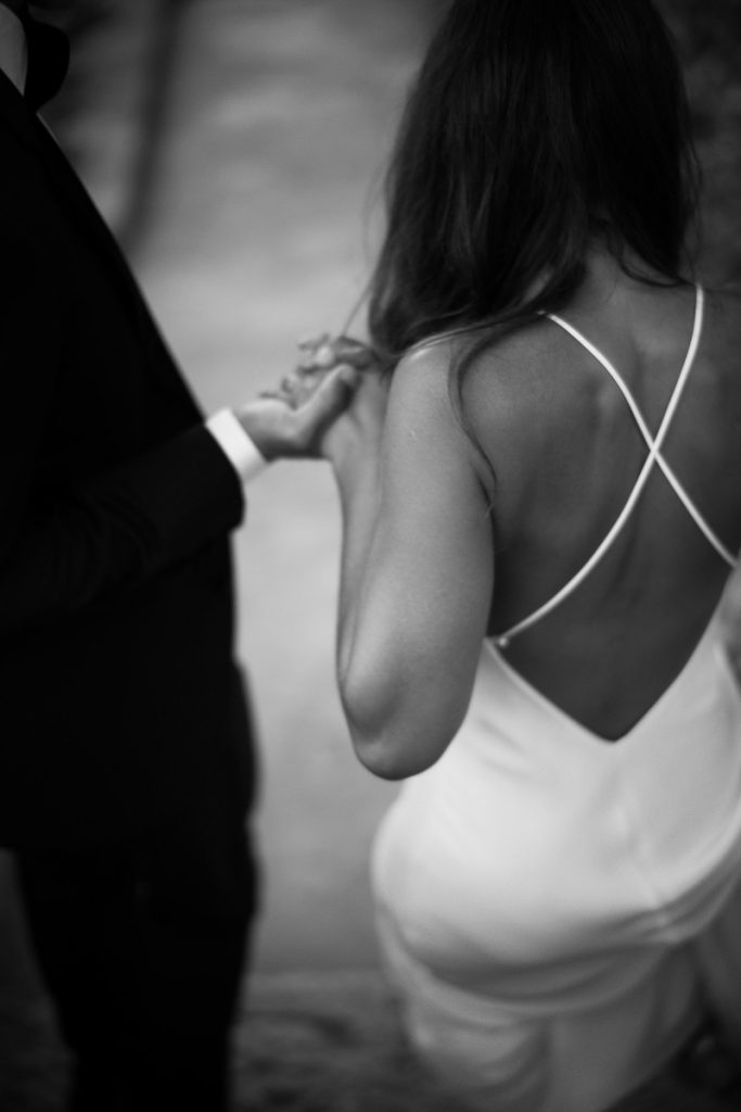 A bride and groom hold hands together, taken by London Wedding Photographer Philip White.